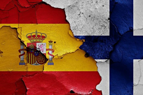 Flags of Spain and Finland painted on cracked wall