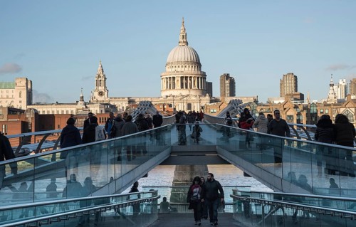 London, United Kingdom, December 8 2015: People walking at the Millennium bridge, officially known