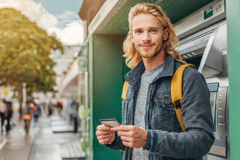 AI generated, A young man with a cheque card withdraws money from an ATM, 25, 30, years