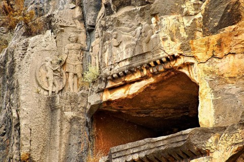 Pictures & images of the ancient Lycian rock cut tomb of a Gladiator whose rock relief sculpture