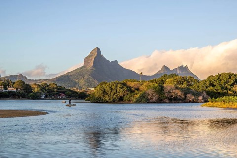 A bay on a river. Dream beach in a pastel-coloured sunset on a holiday island. A gently sloping