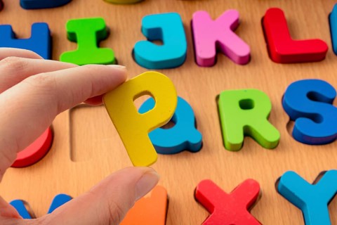 Colorful Letter of Alphabet P made of wood in hand