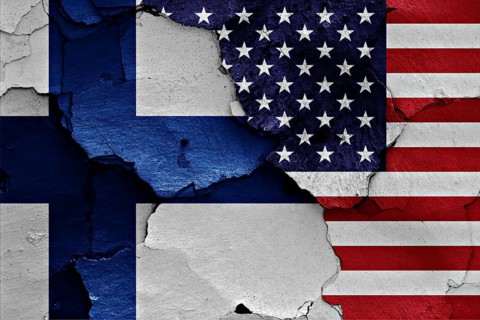 Flags of Finland and USA painted on cracked wall