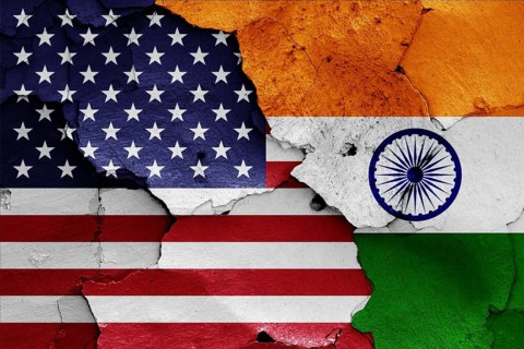 Flags of USA and India painted on cracked wall