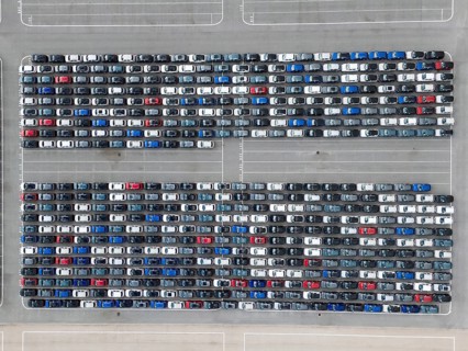 New Cars on Large Parking Lot in Port Ready for Distribution. Harbor Vehicle Storage for Shipping.
