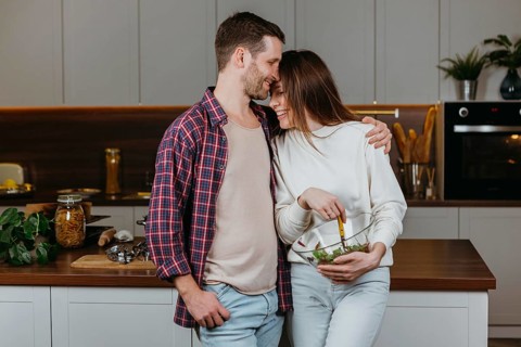 Front view loving couple preparing food home