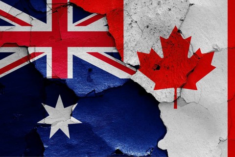 Flags of Australia and Canada painted on cracked wall