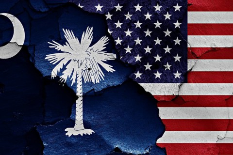 Flags of South Carolina and USA painted on cracked wall