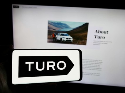 Stuttgart, Germany, 03-18-2024: Person holding smartphone with logo of US peer-to-peer carsharing
