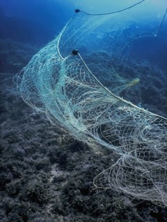 A fishing net underwater fixed on the seabed, deep water