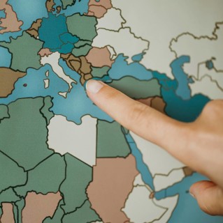 Person pointing europe map