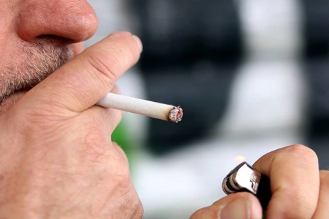 Man lights a cigarette