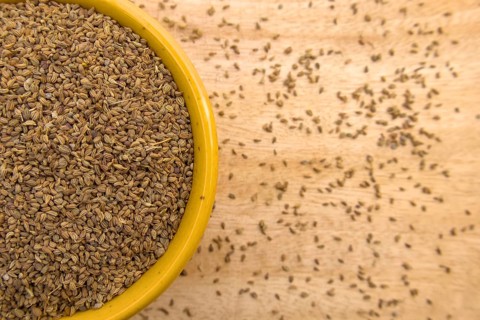 Top View of Ajwain, Carom Seeds, Thymol Seeds, Bishop's Weed in a Yellow Bowl, Closeup