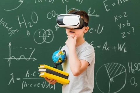 Side view boy wearing virtual reality headset holding books