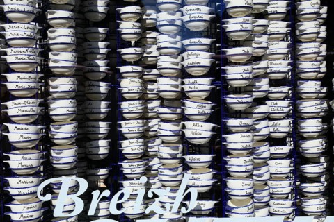 Pottery bowls with first names in the window of a souvenir shop, old town of Vannes, Breton Gwened,