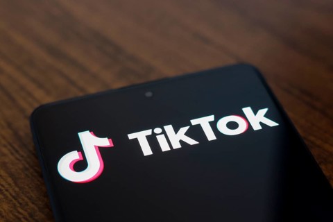 In this photo illustration, the TikTok logo is displayed on a smartphone screen