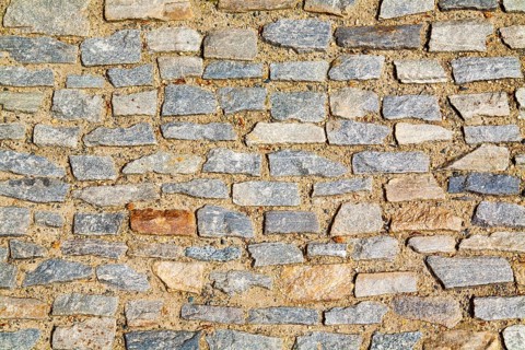 Stone pavement texture. Granite cobblestoned pavement background. Abstract background of old