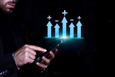 Businessman consulting his mobile phone observing the statistics and monetary balance of his