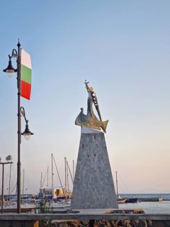 The statue of Saint Nicholas patron of sailors in the old town of Nessebar, Bulgaria. Serene sunset