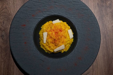 Elegant Plate with Risotto alla Milanese with Saffron and Parmesan Cheese in Lugano, Ticino,