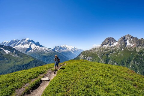 Mountaineer on hiking trail, mountain panorama with glaciated mountain peaks, Aiguille Verte with