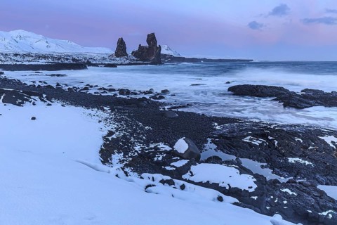 Rocks and surf on the coast, evening light, sun, snow, winter, Arnarstapi, Snaefellsnes,
