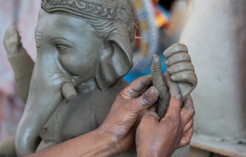Artisan work on idols of the elephant-headed Hindu deity Ganesha at a workshop ahead of the Ganesh