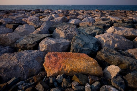 Stones, rocks that form the foundation for the artificial palm island, The Boardwalk, waterfront
