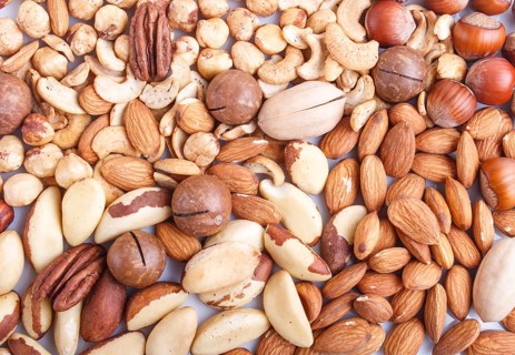 Background and texture made from different kinds of nuts. hazelnut, brazil nut, almond, pumpkin