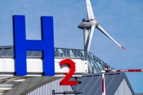 Hydrogen filling station in Antwerp, for cars and lorries, H2 lettering, wind turbine in the