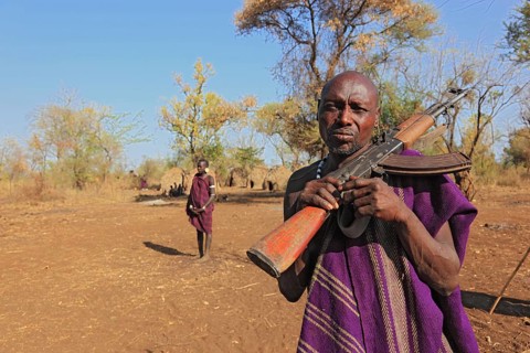South Ethiopia, in the Maco National Park, in the village of the Mursi, Mursi man with rifle,