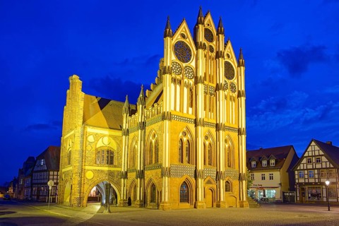 Tangermünde town hall on the market square, surrounded by half-timbered houses, illuminated in the