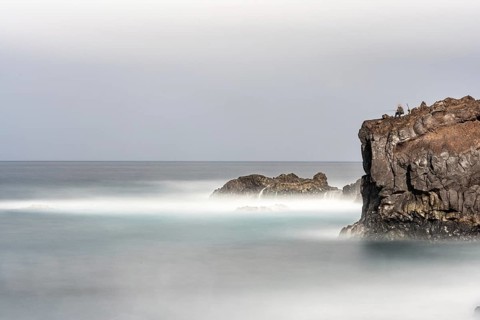 Angler on the beach and rocks, surf on Lanzarote, Spain, Europe