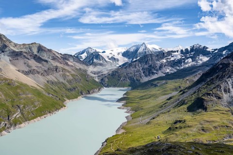 Picturesque mountain landscape, view of a blue mountain lake, Lac des Dix reservoir, behind