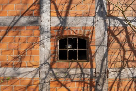 An old rusty window frame of a half-timbered barn, Wildeshauser Geest, Bassum, Diepholz, Lower