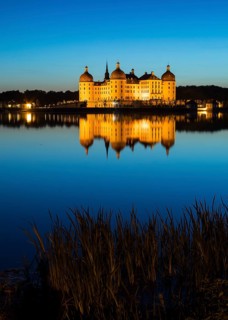 Castle with reflection in the castle pond in the evening, Moritzburg, Saxony, Germany, Europe