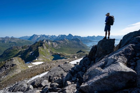 View of mountains and fjord landscape, mountain panorama, mountaineer at the summit of Rundfjellet,
