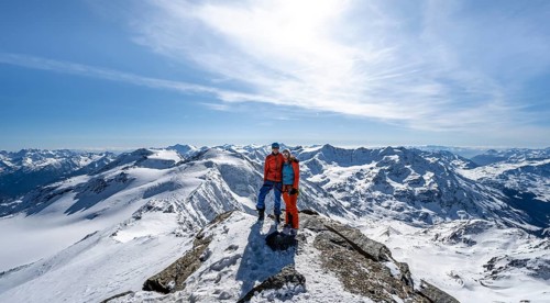 Couple, ski tourers at the summit of Monte Cevedale, mountain panorama, snow-covered mountain