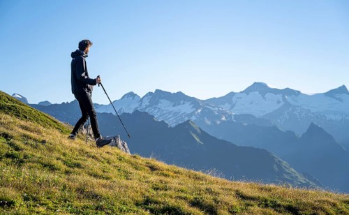 Hiker enjoying the mountain panorama in the morning, Venediger group, behind Dreiherrenkopf,