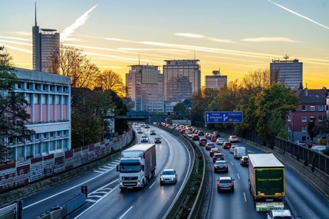 Evening traffic, partly with traffic jams, slow-moving traffic on the A40 motorway, skyline of