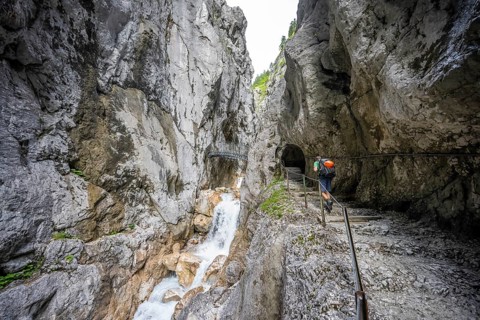 Hammersbach mountain stream in a canyon, mountaineer on a hiking trail in a gorge, Höllentalklamm,