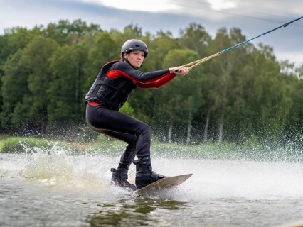 Young man, athletic, fast wakeboarding, water sports, water skiing and wakepark, Stráž pod Ralskem,