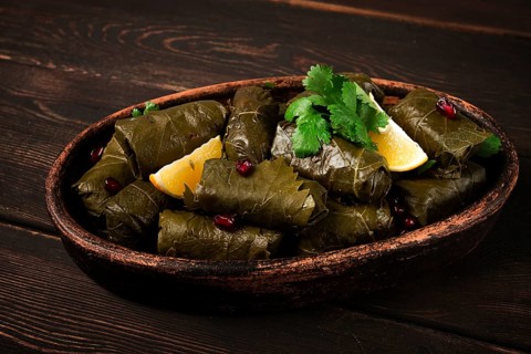 Dolma (Tolma) stuffed rolls, minced meat with rice, in grape leaves, top view, no people, close-up