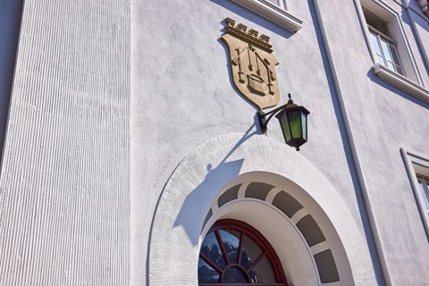Facade of a house in the classicist style with the coat of arms of the salt boiling trade and