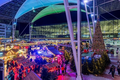 Christmas market at the airport in the evening, market stalls decorated for Christmas in front of