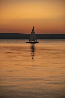 Sailing boat in the sunset with sunset on the Lake Ammer near Herrsching, Bavaria, Germany, Europe