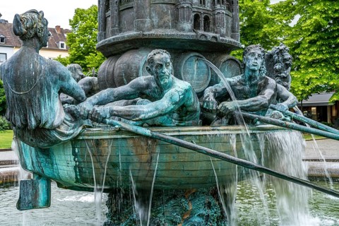 Detail of the historical column of the fountain on Josef-Görres-Platz in the historic centre of