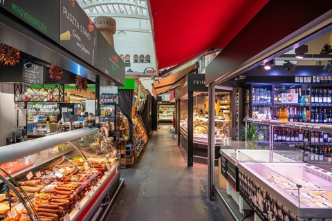 Various market stalls with delicatessen products from different nations in the Markthalle