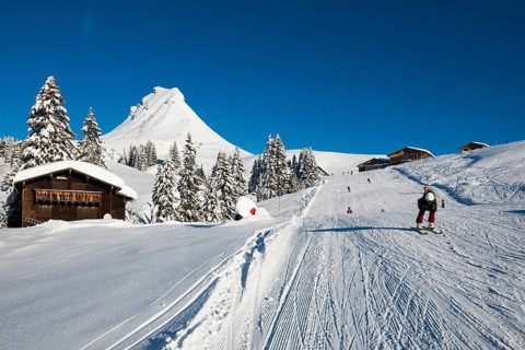 Snow-covered mountains and mountain hut with ski slope, Damülser Mittagspitze, Damüls,