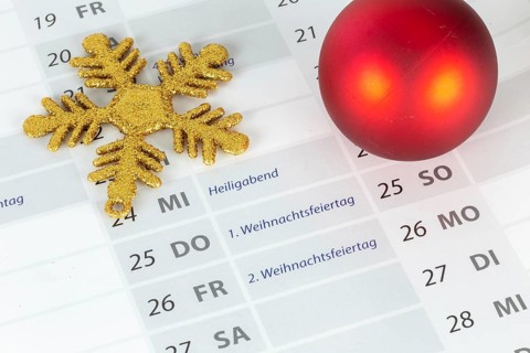 Close-up of a section of a calendar showing the 2025 Christmas holidays with Christmas decorations